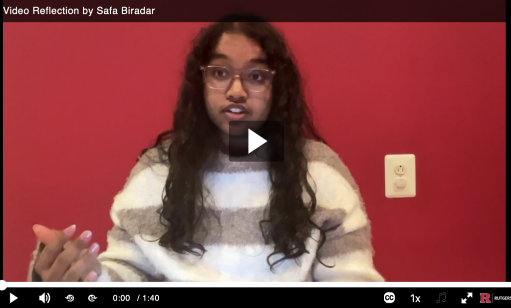 A person speaking in front of a red background